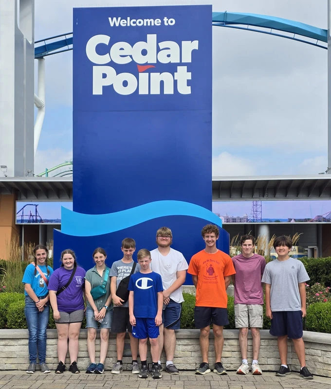 Students by the Cedar Point sign