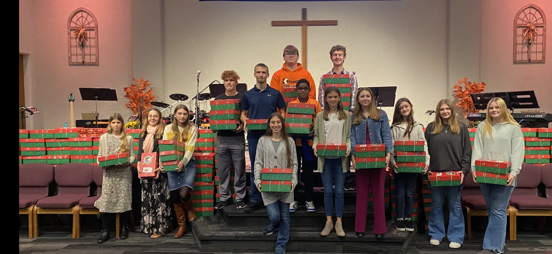 Students holding packed shoeboxes